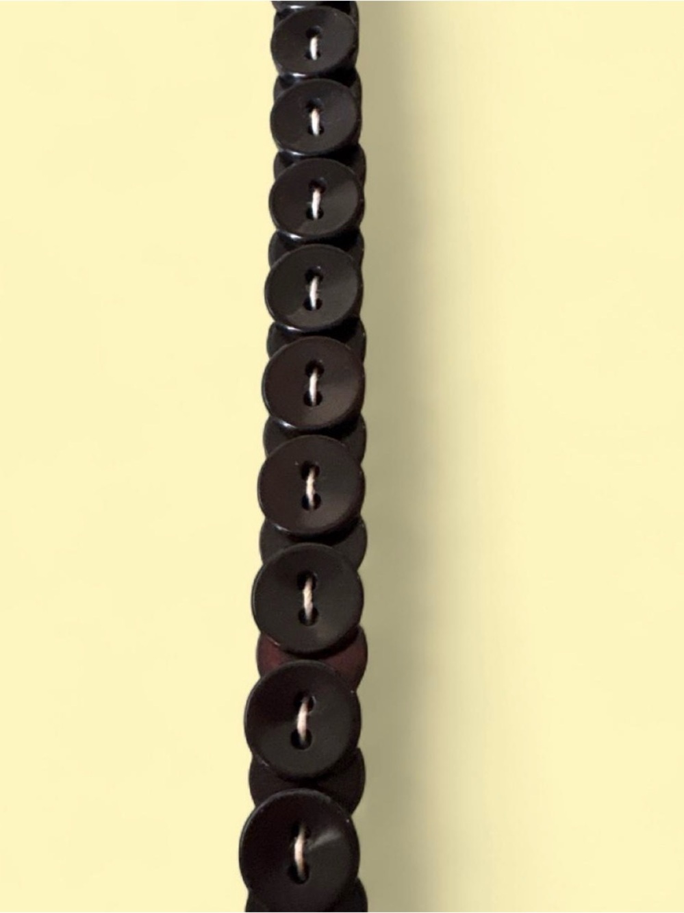 Black vintage handmade stacked button necklace hangs 15”